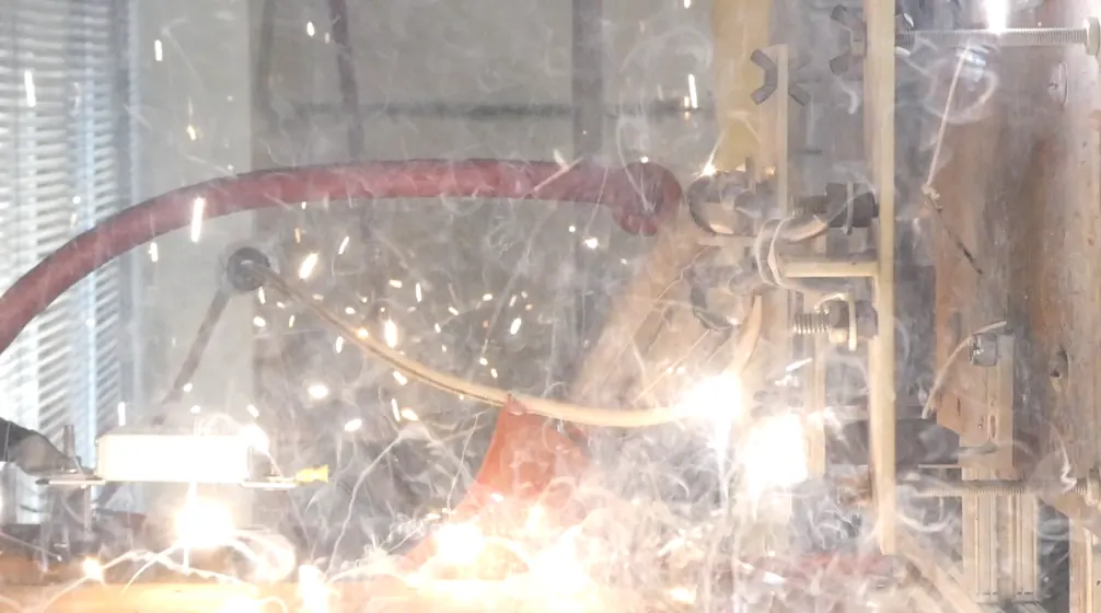 Sparks and smoke erupting from a wire under arc-fault test